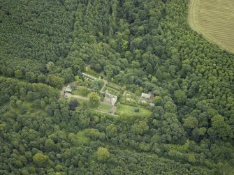 Oblique aerial view centred on the castle, garden and chapel, taken from the NW.