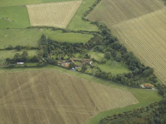 Oblique aerial view centred on the country house, cottage and walled garden, taken from the N.