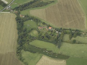 Oblique aerial view centred on the country house, cottage and walled garden, taken from the SSE.