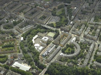 Oblique aerial view centred on the academy with the road bridge adjacent, taken from the NNE.