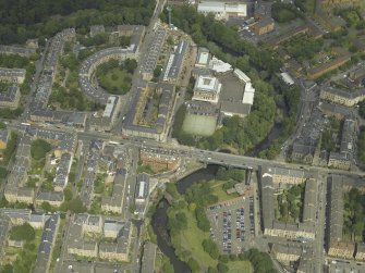 Oblique aerial view centred on the academy  and road bridge, taken from the SSW.