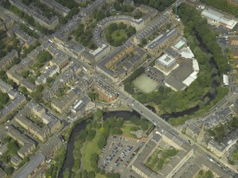 Oblique aerial view centred on the academy  and road bridge, taken from the SSE.