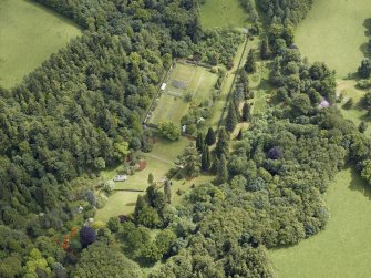 Oblique aerial view centred on the walled garden and the garden house, taken from the NW.