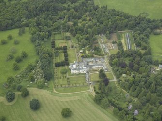 Oblique aerial view centred on the country house, walled garden, gardens and terraces, taken from the ESE.