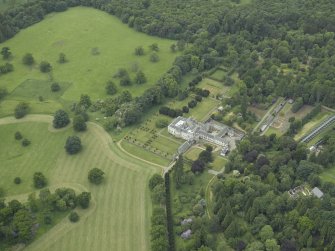 General oblique aerial view centred on the country house, walled garden, gardens and terraces, taken from the E.