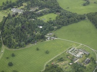 General oblique aerial view centred on the farmsteading and stallion house with the country house adjacent, taken from the ENE.
