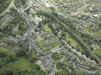 Oblique aerial view of the town centred on the cathedral, chapel, burial-ground and hall, taken from the NNE.