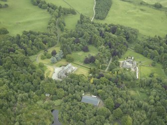 Oblique aerial view centred on the country house, walled garden and farmsteading, taken from the NW.