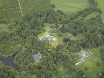 Oblique aerial view centred on the country house, walled garden and farmsteading, taken from the W.