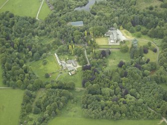 Oblique aerial view centred on the country house, walled garden and farmsteading, taken from the S.