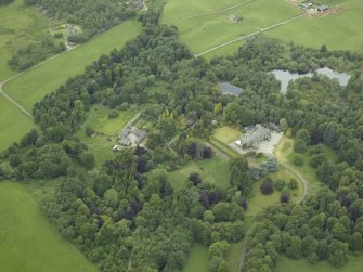 General oblique aerial view centred on the country house, walled garden and farmsteading, taken from the E.