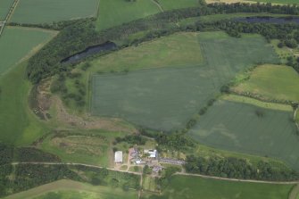 Oblique aerial view centred on the cropmarks of the gardens with the farmhouse, cartshed, granary and farmsteading adjacent, taken from the SE.