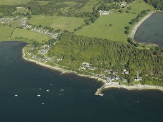 General oblique aerial view of the village centred on the jetty and ferry house with the country house and farmsteading adjacent, taken from the WNW.