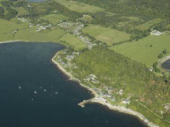 General oblique aerial view of the village centred on the jetty and ferry house with the farmsteading adjacent, taken from the W.