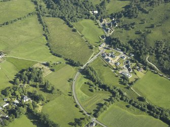 General oblique aerial view centred on the village with the country house, church and burial-ground adjacent, taken from the NW.