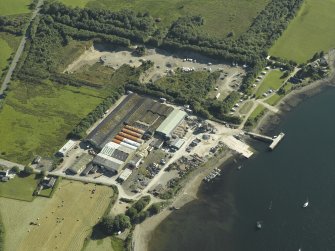 Oblique aerial view centred on the works with the pier adjacent, taken from the NE.