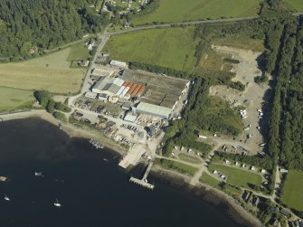 Oblique aerial view centred on the works with the pier adjacent, taken from the NW.