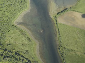 Oblique aerial view centred on the remains of the crannog, taken from the WNW.