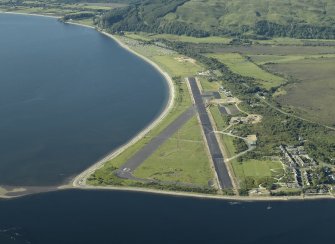 General oblique aerial view centred on the airfield during resurfacing of the runway, taken from the S.