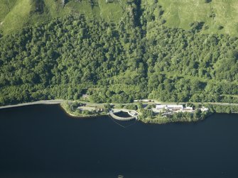 Oblique aerial view centred on the electricity generating station and the military way, taken from the SW.