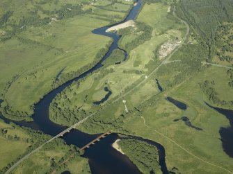 General oblique aerial view centred on the railway viaduct and road bridge with the sawmill adjacent, taken from the W.