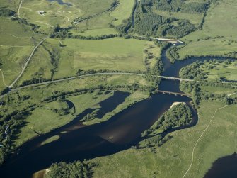 General oblique aerial view centred on the railway viaduct and road bridge, taken from the SSW.