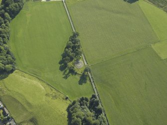 Oblique aerial view centred on the remains of the stone circles with the remains of the standing stone adjacent, taken from the SW.