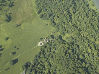 General oblique aerial view centred on ruins of the country house, taken from the NE.