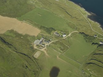 Oblique aerial view centred on the farmhouses, farmsteading and cottages, taken from the E.