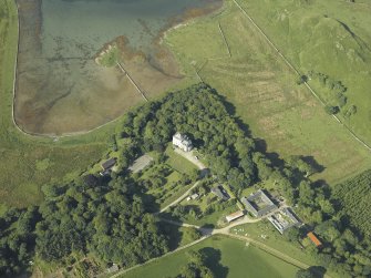 Oblique aerial view centred on the castle and the farmstead, taken from the NE.