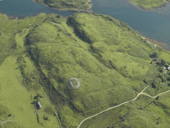 Oblique aerial view centred on the remains of the dun, taken from the SW.