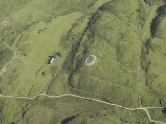 Oblique aerial view centred on the remains of the dun, taken from the S.