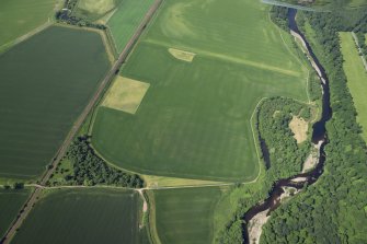 Oblique aerial view centred on the cropmarks of the rig with the cropmarks of the possible unenclosed settlement adjacent, taken from the NE.