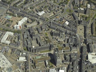 Oblique aerial view centred on the friary, colleges, hospital, churches, tolbooth and cathedral, taken from the SW.