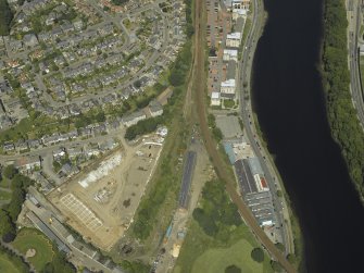 Oblique aerial view centred on the railway engine shed and turntable, taken from the SSE.