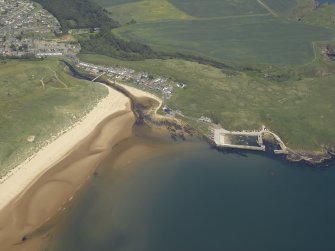 General oblique aerial view centred on the village and the harbour, taken from the SSW.