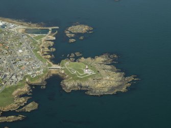Oblique aerial view centred on the lighthouse and road bridge, taken from the SSW.