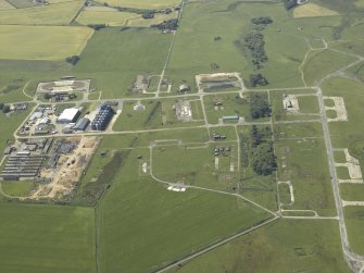 Oblique aerial view of the farmsteading, farmhouse and the remains of the airfield, taken from the E.