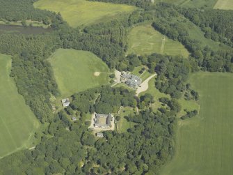 Oblique aerial view centred on the country house, stable block and walled garden, taken from the WSW.
