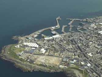 General oblique aerial view of the town centred on the harbour, taken from the WNW.