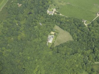 Oblique aerial view centred on the country house with the house adjacent, taken from the WSW.