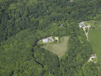 Oblique aerial view centred on the country house with the house adjacent, taken from the S.
