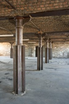 Interior. 3rd floor. View of cast-iron columns, beams and brick arched structure.