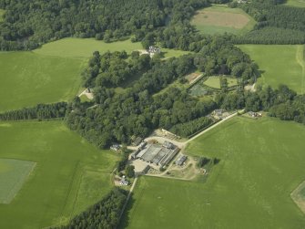 General oblique aerial view centred on the castle, tower-house, walled garden and farmsteading, taken from the S.