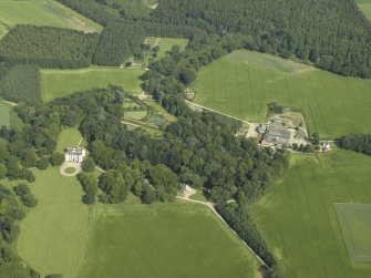 General oblique aerial view centred on the castle, tower-house, walled garden and farmsteading, taken from the W.