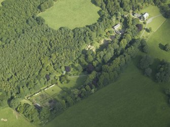 Oblique aerial view centred on the country house with the walled garden adjacent, taken from the WNW.