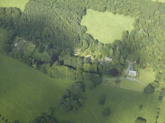 Oblique aerial view centred on the country house with the walled garden adjacent, taken from the WSW.