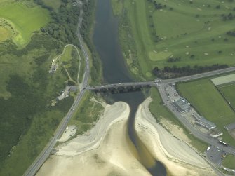 Oblique aerial view centred on the road bridge with the gate-lodge adjacent, taken from the N.