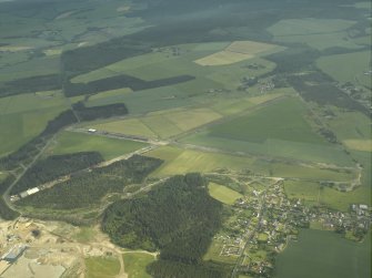General oblique aerial view centred on the remains of the airfield with the village adjacent, taken from the NNW.