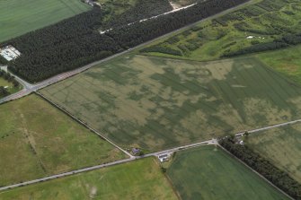 Oblique aerial view centred on the cropmarks of the pits and frost wedges, taken from the N.